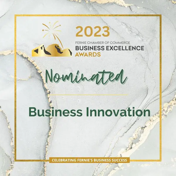 A gold and white business award with the words " nominated " in front of it.