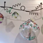 A group of glass ornaments hanging from a wire.