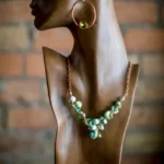 A necklace and earrings set on display in a mannequin.