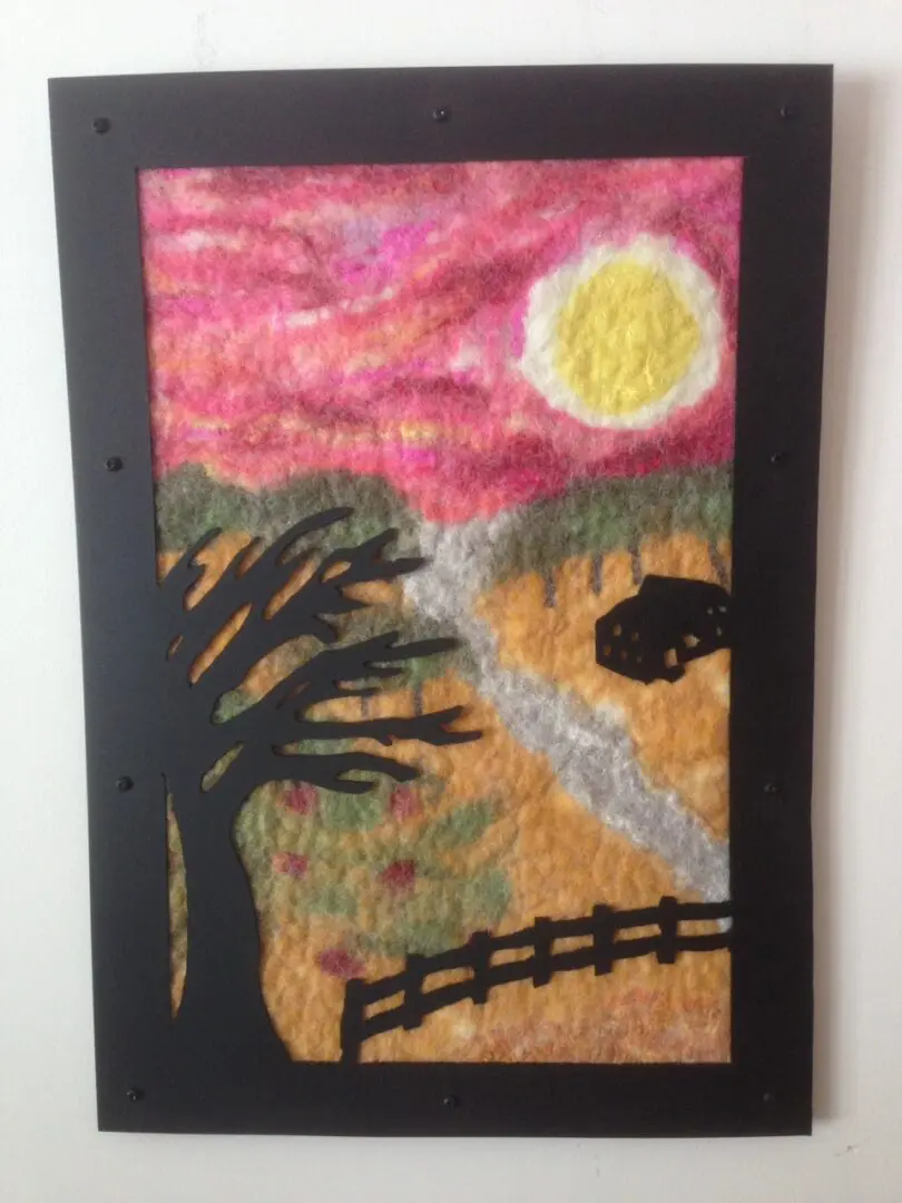 A painting of a tree and sun in the background.