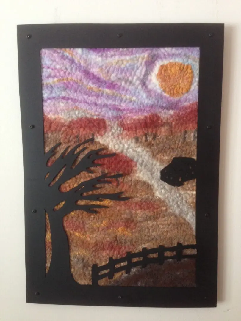 A painting of a tree and sun in the background.
