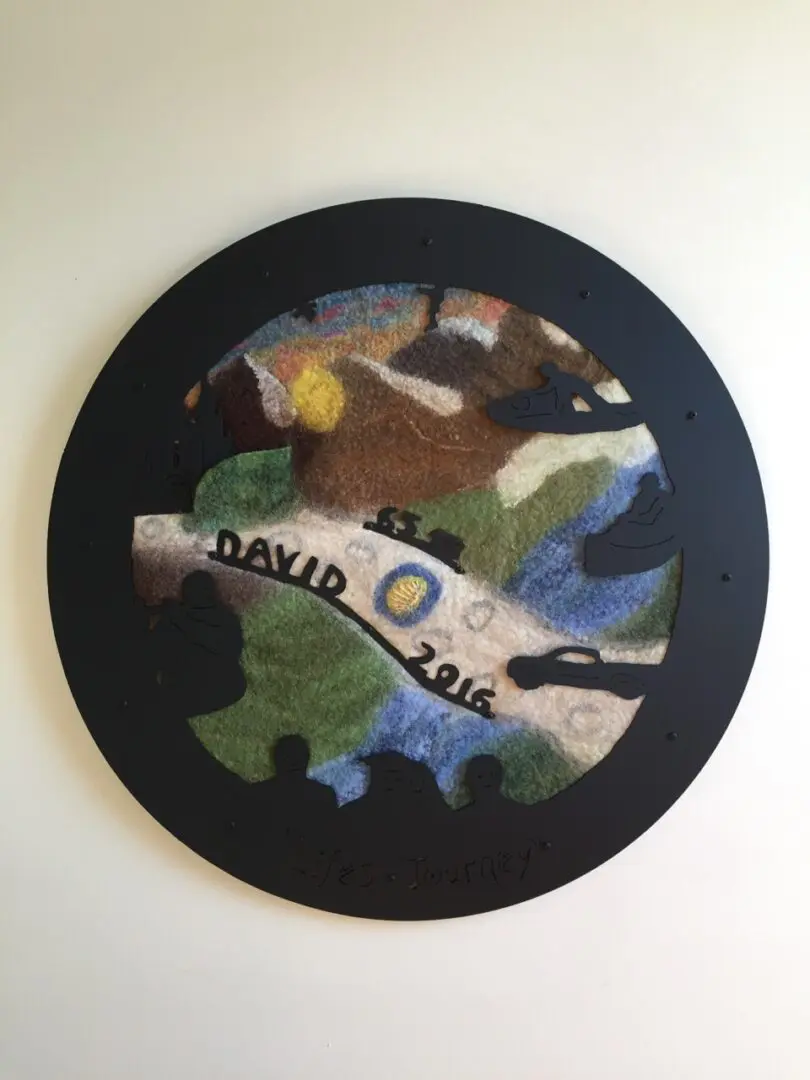A round painting of trees and leaves with the name david zois.