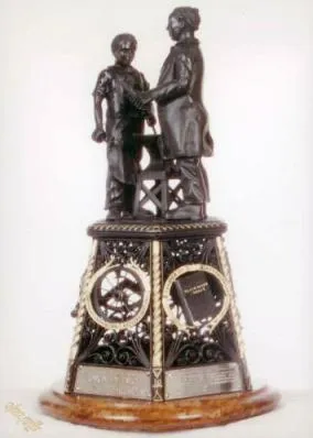 A statue of two men holding hands on top of a clock tower.