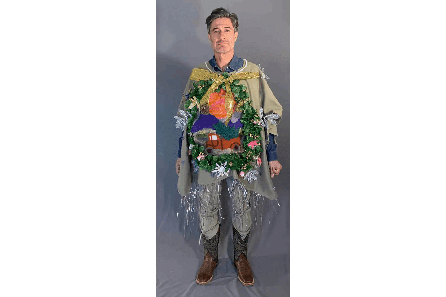 A man in a costume with a wreath on his chest.