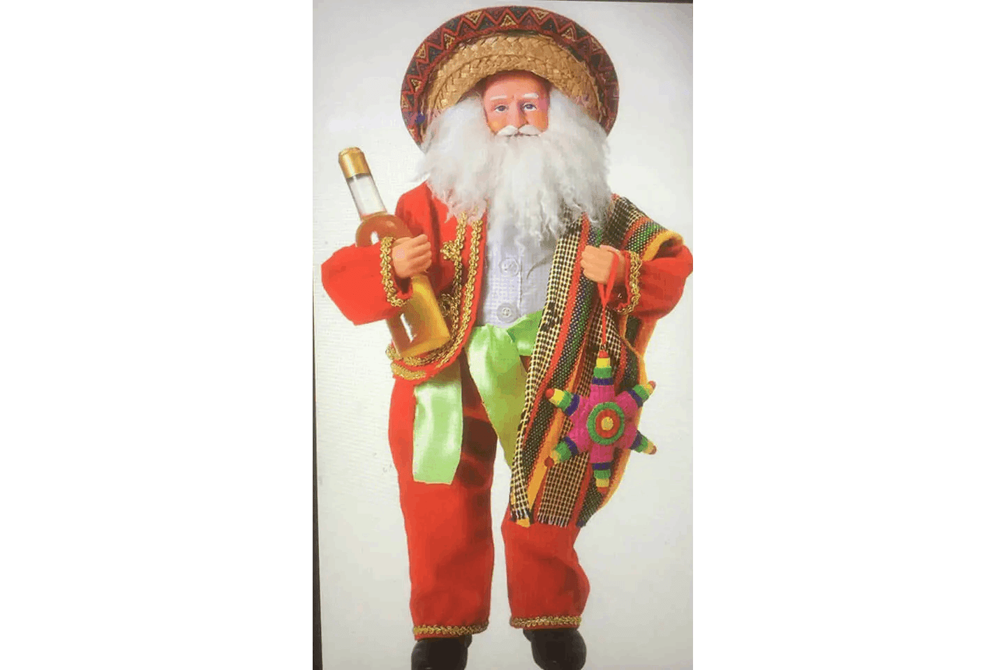 A santa clause doll with a hat and beard.
