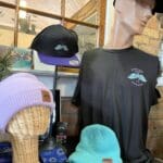 A mannequin wearing a hat and a t-shirt.