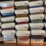A wall of many different colored thread.