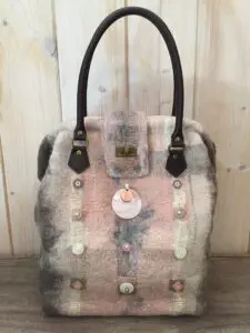 A bag with buttons and fur on it